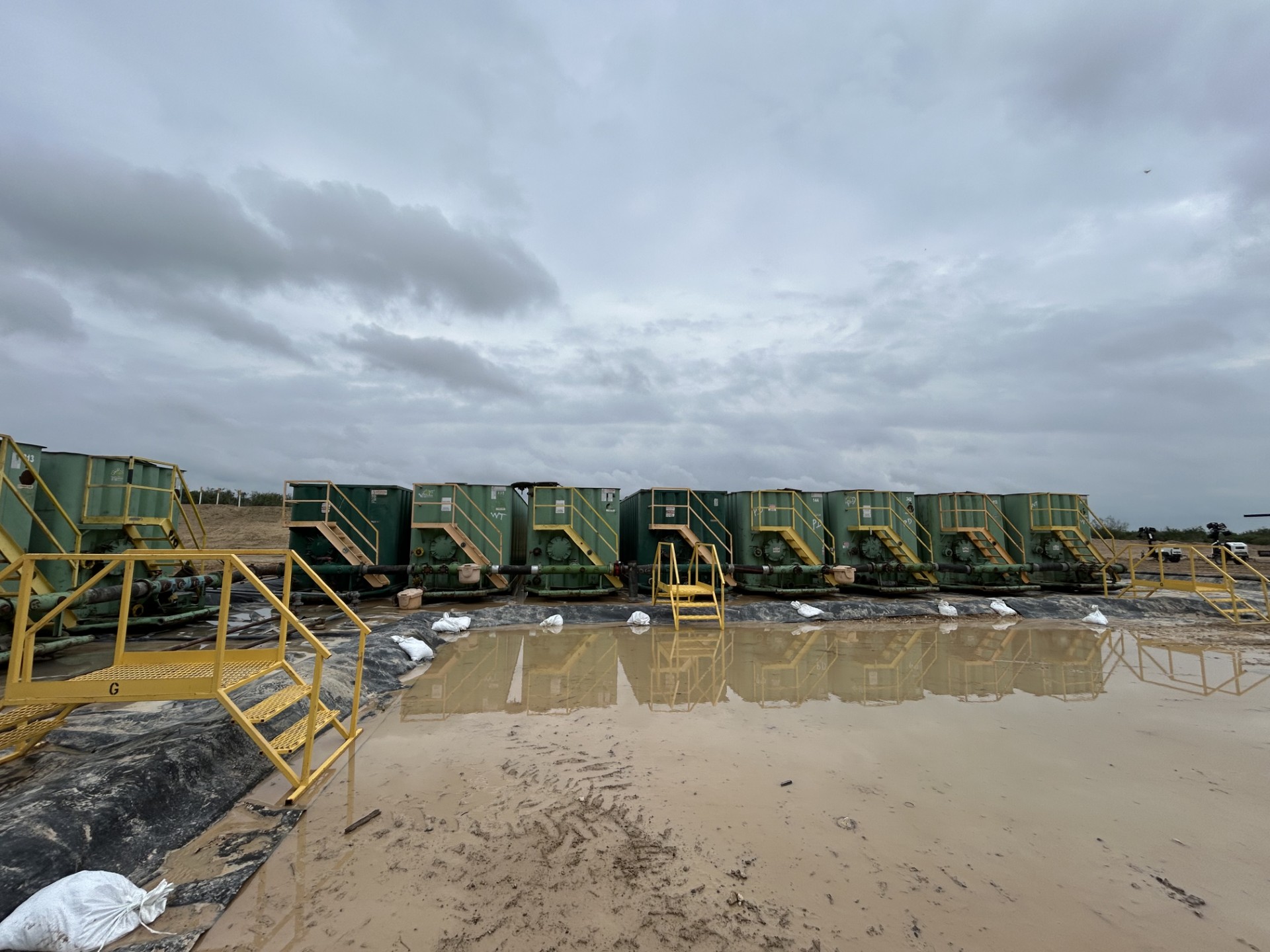 Row of Heartbreak Trucking frac tanks set up on a job site