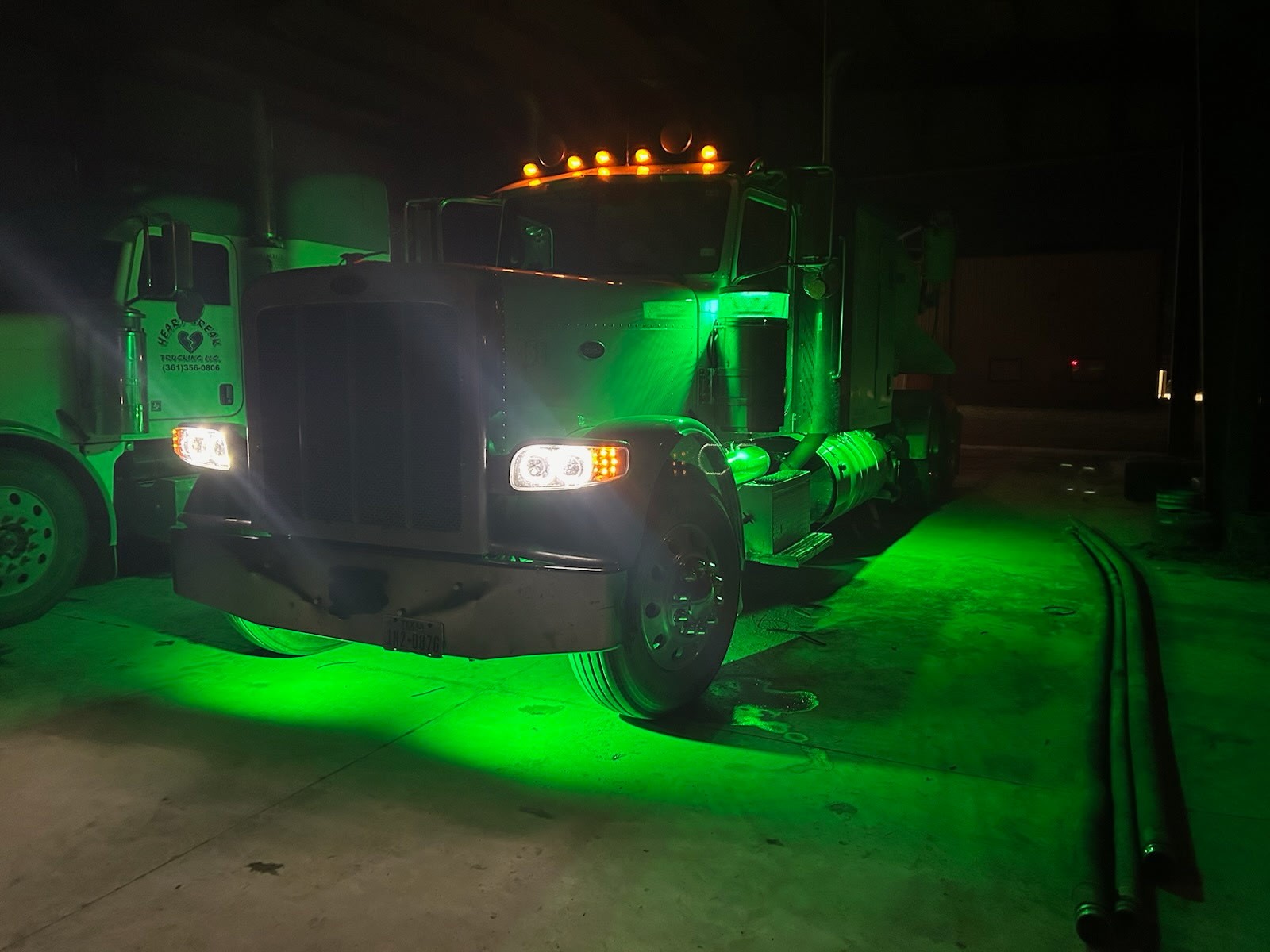 Truck in the shop with green underglow